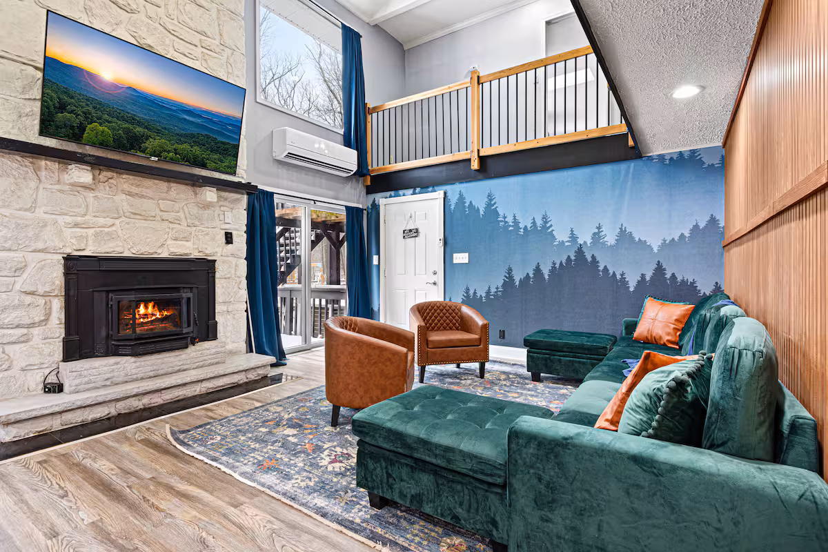 Living room with stone fireplace and emerald sectional