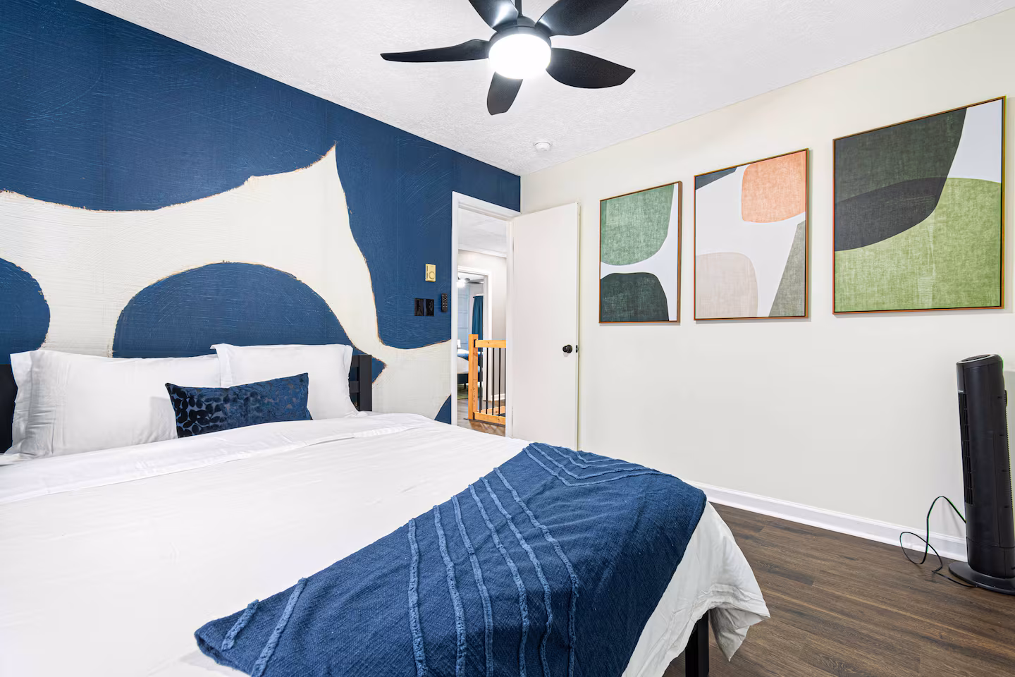 Bedroom with bold abstract mural wall