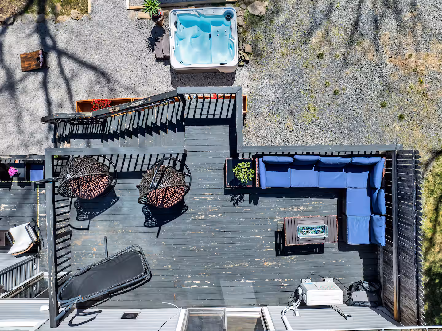 Aerial view of deck with egg chairs and hot tub below